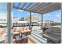 Spacious rooftop deck with a grill, comfortable seating, and a pergola at 907 Arlington N Ave, St Petersburg, FL 33705