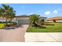 Attractive home with brick driveway, well-kept lawn, and lush landscaping at 10505 Inglenook Ter, Palmetto, FL 34221