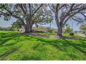 Beautiful home with a sprawling front yard and mature trees creating a serene setting at 1129 Haley Ln, Dunedin, FL 34698