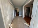 Entryway with tile floors, white closet doors, and open doorway into adjacent room at 11708 Nicklaus Cir, Tampa, FL 33624