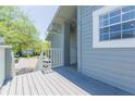 A large balcony overlooking a parking lot and neighboring trees in a tranquil and relaxing setting at 11868 Skylake Pl # 11767, Temple Terrace, FL 33617