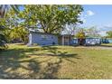 Charming single-story home featuring a well-maintained lawn and mature trees providing ample shade at 1411 Barry St, Clearwater, FL 33756