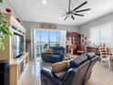 Bright living room featuring tile floors, modern ceiling fan, water view, and comfortable furniture at 200 Brightwater Dr # 10, Clearwater Beach, FL 33767
