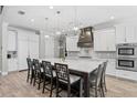Bright kitchen with large island, stainless appliances, modern lighting and seating at 2316 S Thixton Ct, Tampa, FL 33629
