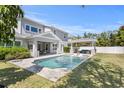 Backyard boasts a stunning pool, outdoor kitchen and covered seating area at 2316 S Thixton Ct, Tampa, FL 33629