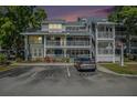 Exterior view of complex with well-kept landscaping and parking area in front at 2599 Dolly Bay Dr # 209, Palm Harbor, FL 34684