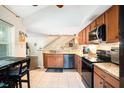 Kitchen featuring granite countertops, stainless appliances, and tile flooring at 2599 Dolly Bay Dr # 209, Palm Harbor, FL 34684