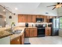 Kitchen features granite countertops, updated appliances, and vaulted ceilings at 2599 Dolly Bay Dr # 209, Palm Harbor, FL 34684