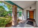Inviting front porch with brick column and stylish front door at 3051 Egret Ter, Safety Harbor, FL 34695