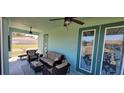 Inviting screened-in lanai with comfortable seating, ceiling fans, and a tranquil view at 3190 Darius Ave, North Port, FL 34288