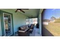 Cozy screened-in lanai with stylish furnishings, ceiling fans, and outdoor living space at 3190 Darius Ave, North Port, FL 34288