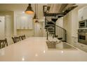 Modern kitchen featuring a spiral staircase, stainless steel appliances, and a large center island at 35150 Roth Ln, Dade City, FL 33525