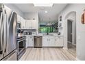 Modern kitchen featuring stainless steel appliances, sleek white cabinets, and ample counter space at 3621 Country Pointe Pl, Palm Harbor, FL 34684