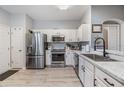 Bright kitchen featuring stainless steel appliances and white cabinets at 3621 Country Pointe Pl, Palm Harbor, FL 34684