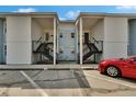 Multi-Gathering condo with well-maintained facade, black railings, and a glimpse of a parked red car at 3821 N Oak Dr # J31, Tampa, FL 33611