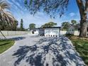 Charming single-story home with a paved driveway and well-maintained landscaping under a blue sky at 4619 Helena Ne St, St Petersburg, FL 33703