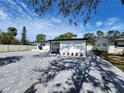 Charming single-story home with a paved driveway and well-maintained landscaping under a blue sky at 4619 Helena Ne St, St Petersburg, FL 33703
