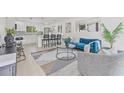 Open-concept living area with bright lighting, modern furniture, and stylish decor at 4727 W Wisconsin Ave, Tampa, FL 33616
