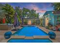 Inviting outdoor pool area with a beautifully landscaped deck and stylish patio furniture at 5127 29Th S Ave, Gulfport, FL 33707