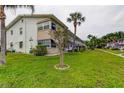 Well-maintained condo building with manicured lawn and palm trees, creating a serene setting at 5876 21St N St # 10, St Petersburg, FL 33714