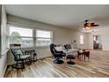 Inviting living room with lots of natural light, neutral paint, comfortable seating, and wood-look floors at 5876 21St N St # 10, St Petersburg, FL 33714