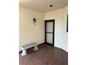 Inviting entryway with a brick-style tile floor, bench, and updated front door at 5990 Terrace Park N Dr # 109, St Petersburg, FL 33709