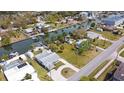 Aerial view of a waterfront community featuring boat docks, lush landscaping, and serene canal views at 6801 Clark St, Hudson, FL 34667