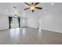 Sun-filled living room with large windows and neutral tile floors at 783 41St Ne Ave, St Petersburg, FL 33703