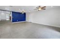 Spacious living room featuring recessed lights, ceiling fans, and bold blue accent wall at 783 41St Ne Ave, St Petersburg, FL 33703