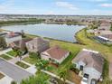 Aerial view of a home near a scenic lake showcasing the neighborhood's layout and community at 810 Fern Leaf Dr, Ruskin, FL 33570