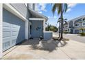 Close-up of a townhouse featuring a garage door, front entryway, and nautical-themed mermaid decor at 911 Harbour House Dr, Indian Rocks Beach, FL 33785
