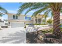 Stunning two-story home featuring a manicured front yard, two-car garage and a neutral exterior color palette at 931 Inlet Cir, Venice, FL 34285