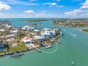 Aerial view of waterfront homes featuring boat docks and panoramic ocean views at 931 Inlet Cir, Venice, FL 34285