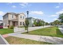 Charming home with a red front door, white picket fence, and a neatly trimmed lawn along the sidewalk at 11109 Great Neck Rd, Riverview, FL 33578