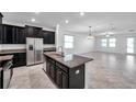 Modern kitchen showcasing granite countertops, a kitchen island, and stainless steel appliances at 11820 Sunburst Marble Rd, Riverview, FL 33579