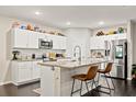 Bright kitchen with white cabinetry, granite countertops, and stainless steel appliances at 13110 Shumard Way, Riverview, FL 33579