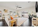 Spacious living room with hardwood floors, ample natural light, and access to the backyard at 13110 Shumard Way, Riverview, FL 33579