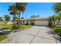 Charming home featuring a well-maintained lawn, two-car garage, and inviting curb appeal at 1508 Eden Isle Ne Blvd, St Petersburg, FL 33704