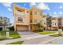 Charming multi-story townhome with a well-maintained lawn, two-car garage, and a private balcony at 1537 Ember Ln, Tarpon Springs, FL 34689