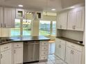 Bright kitchen featuring white cabinetry, stainless steel appliances, and a view of the pond at 1655 S Highland Ave # I286, Clearwater, FL 33756