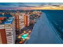 Wide angle aerial of the beachfront condo buildings, the beach, and the city's coastal area at dusk at 17920 Gulf Blvd # 2004, Redington Shores, FL 33708