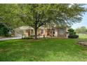 Charming single-story home boasts a well-manicured lawn and beautiful landscaping with mature trees at 18241 Autumn Lake Blvd, Hudson, FL 34667