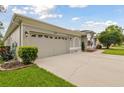Exterior shot of the home showing garage, front yard, and architectural details at 2159 Warwick Dr, Oldsmar, FL 34677