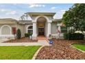 Inviting front entrance with columns and double doors offering curb appeal at 2159 Warwick Dr, Oldsmar, FL 34677