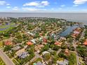 An aerial view of the neighborhood highlighting the subject property with a red pin near golf course and water access at 219 Rialto Ne Way, St Petersburg, FL 33704