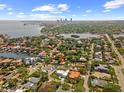 An aerial view of a neighborhood with the subject property marked by a red pin, showcasing proximity to the city skyline at 219 Rialto Ne Way, St Petersburg, FL 33704