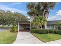 Charming two-story home with well-manicured landscaping and inviting carport area at 2647 Barksdale Ct, Clearwater, FL 33761