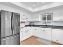 Bright kitchen with white cabinets, modern appliances, and a window that provides natural light at 2647 Barksdale Ct, Clearwater, FL 33761