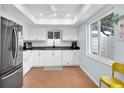 Bright kitchen with white cabinets, modern appliances, and a window that provides natural light at 2647 Barksdale Ct, Clearwater, FL 33761
