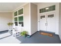 Cozy front porch with rocking chairs and decorative plants, perfect for relaxing and enjoying the outdoors at 3027 Key Harbor Dr, Safety Harbor, FL 34695